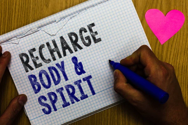 Handwriting text Recharge BodyandSpirit. Concept meaning fill your energy through relaxation and having fun Paper register multiline text pen handwriting love heart table background