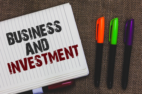 Text sign showing Business And Investment. Conceptual photo putting your money in field to increase them Open notebook page jute background colorful markers Expressing ideas