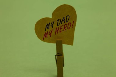 Handwriting text My Dad My Hero. Concept meaning Admiration for your father love feelings emotions compliment Celadon color background paper clip hold love heart for loving with words
