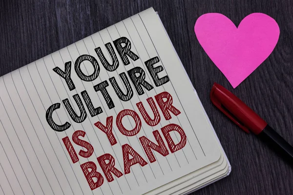 Writing note showing Your Culture Is Your Brand. Business photo showcasing Knowledge Experiences are a presentation card Strikethrough words on notepad love heart pen on blackish woody desk