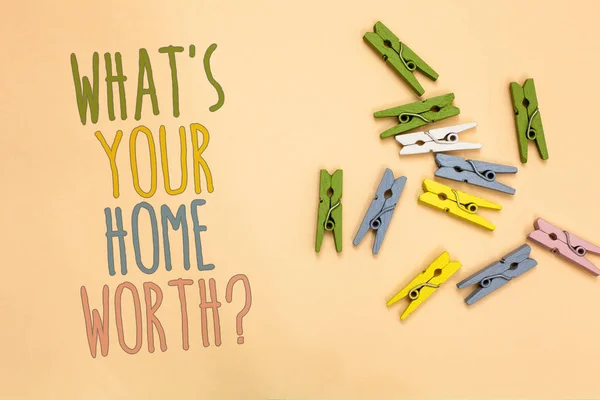Text sign showing What s is Your Home Worth question. Conceptual photo Value of a house Property Cost Price Rate Yellow base with painted texts colorful paper clips laid randomly on ground