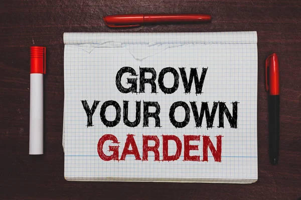 Handwriting text writing Grow Your Own Garden. Concept meaning Organic Gardening collect personal vegetables fruits Written black, red words notepad on brown stage white highlighter red pens
