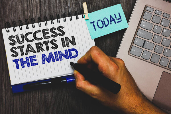Word writing text Success Starts In The Mind. Business concept for Have positive thoughts accomplish what you want Paperclip grip sticky note with text hand hold pen computer on wooden desk