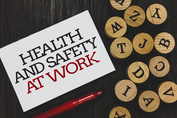 Text sign showing Health And Safety At Work. Conceptual photo Secure procedures prevent accidents avoid danger Written paper red marker beside round woody alphabets on wooden base