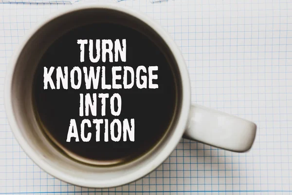 Writing note showing Turn Knowledge Into Action. Business photo showcasing Apply what you have learned Leadership strategies Coffee mug with black coffee floating some white texts on white paper