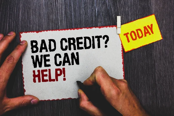 Handwriting text writing Bad Credit question We Can Help. Concept meaning Borrower with high risk Debts Financial Hand grip black marker writing text paperclip stick written page woody deck