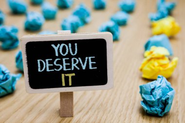 Conceptual hand writing showing You Deserve It. Business photo text Reward for something well done Deserve Recognition award poster board with blurry paper lobs laid serially mid yellow lob clipart