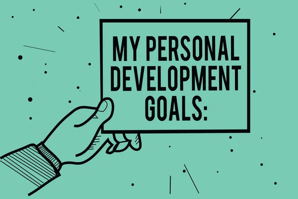 Text sign showing My Personal Development Goals. Conceptual photo Desires Wishes Career Business planning Man hand holding paper communicating information dots turquoise background