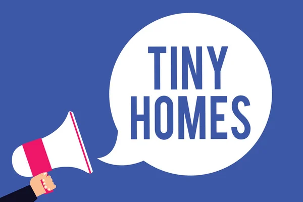 Text sign showing Tiny Homes. Conceptual photo houses contain one room only or two and small entrance Cheap Man holding megaphone loudspeaker speech bubble screaming blue background