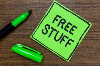 Conceptual hand writing showing Free Stuff. Business photo showcasing Any thing that you can have in a store that is not being paid Green Paper Communicate ideas Marker Wooden background clipart