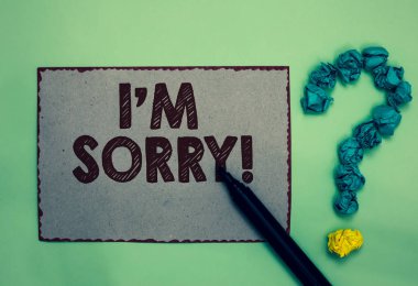 Word writing text I am Sorry. Business concept for To ask for forgiveness to someone you unintensionaly hurt Gray paper marker crumpled papers forming question mark green background clipart