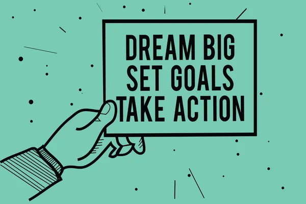 Text sign showing Dream Big Set Goals Take Action. Conceptual photo Motivation to follow your dreams Inspiration Man hand holding paper communicating information dots turquoise background