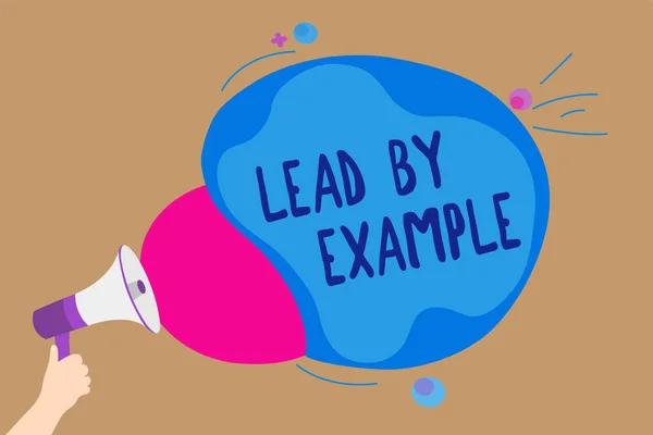 Handwriting text writing Lead By Example. Concept meaning Be a mentor leader follow the rules give examples Coach Man holding Megaphone loudspeaker screaming talk colorful speech bubble