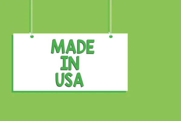 Handwriting text Made In Usa. Concept meaning American brand United States Manufactured Local product Hanging board message communication open close sign green background