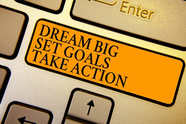 Text sign showing Dream Big Set Goals Take Action. Conceptual photo Motivation to follow your dreams Inspiration Keyboard orange key Intention create computer computing reflection document