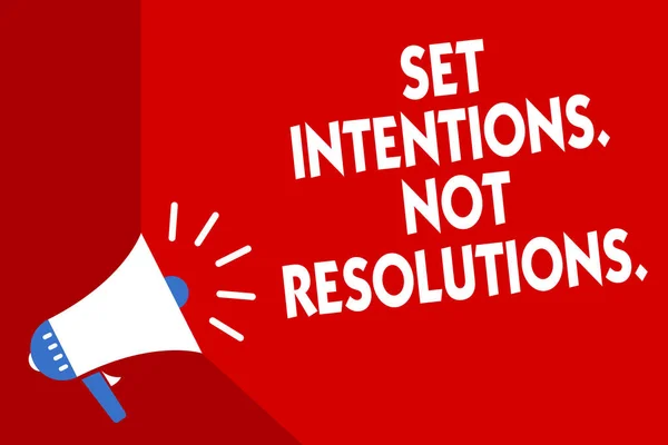 Conceptual hand writing showing Set Intentions. Not Resolutions.. Business photo showcasing Positive choices for new start achieve goals Megaphone red background important message speaking loud