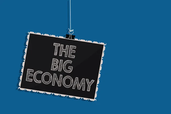 Writing note showing The Big Economy. Business photo showcasing Global finances Worldwide Market Trade Money exchange Hanging blackboard message communication information blue background