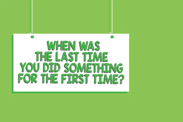 Handwriting text When Was The Last Time You Did Something For The First Time question. Concept meaning 0 Hanging board message communication open close sign green background