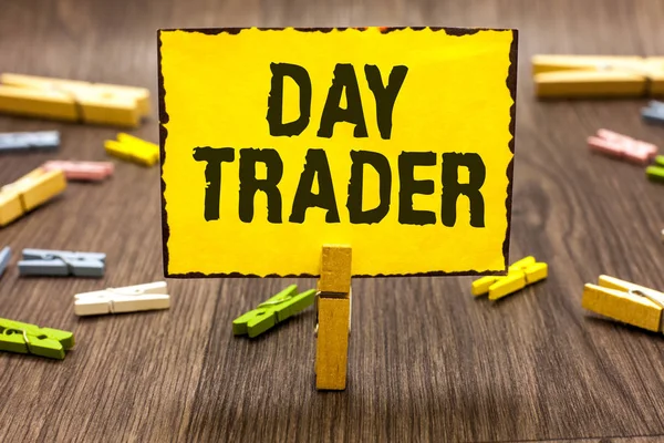 Text sign showing Day Trader. Conceptual photo A person that buy and sell financial instrument within the day Clothespin holding yellow paper note several clothespins wooden floor
