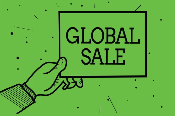 Text sign showing Global Sale. Conceptual photo managers operations for companies do business internationally Man hand holding paper communicating information dotted green background