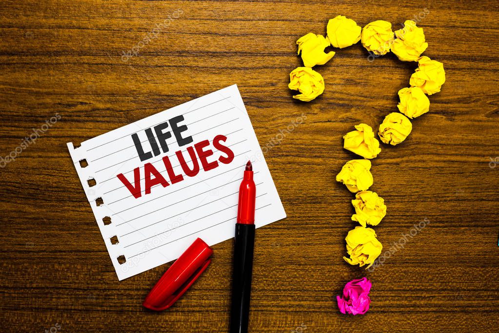 Handwriting text Life Values. Concept meaning things that you believe are important in the way you live Paper marker crumpled papers forming question mark wooden background