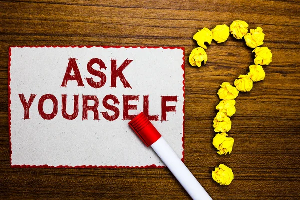 Text sign showing Ask Yourself. Conceptual photo Thinking the future Meaning and Purpose of Life Goals White paper marker crumpled papers forming question mark wooden background