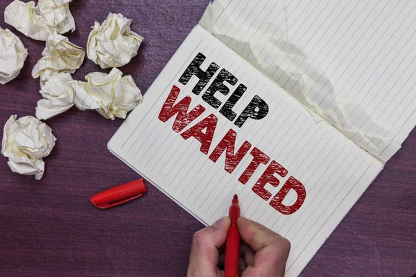 Handwriting text Help Wanted. Concept meaning advertisement placed in newspaper by employers seek employees Man holding marker notebook page crumpled papers several tries mistakes