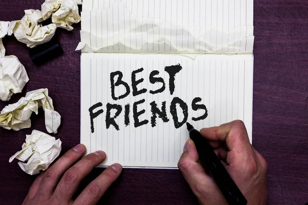Word writing text Best Friends. Business concept for A person you value above other persons Forever buddies Man holding marker notebook page crumpled papers several tries mistakes