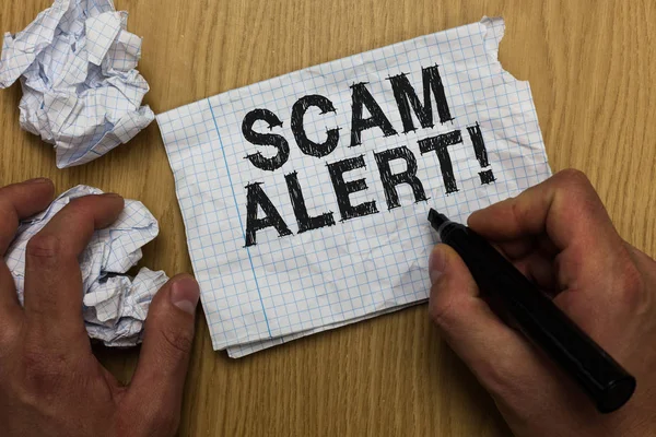 Writing note showing Scam Alert. Business photo showcasing warning someone about scheme or fraud notice any unusual Man holding marker notebook paper crumpled papers several tries