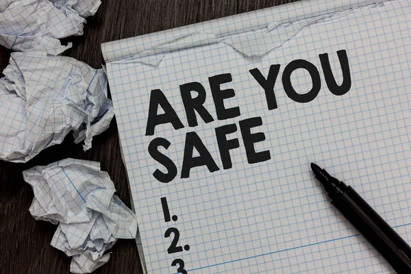 Text sign showing Are You Safe. Conceptual photo Free from danger Not anticipating any Harm Hurt physically Marker over notebook crumpled papers ripped pages several tries mistakes