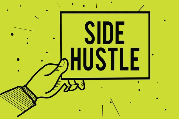 Handwriting text Side Hustle. Concept meaning way make some extra cash that allows you flexibility to pursue Man hand holding paper communicating information dotted yellow background