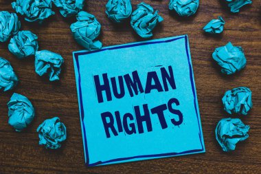 Word metin yazma insan hakları. Ahlaki ilkeleri standartları normlarına uygun bir insan için iş kavramı hukuk mavi kağıt Not buruşuk hatırlatma kağıtları tarafından birkaç kez ahşap arka plan korumalı..