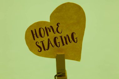 Word writing text Home Staging. Business concept for Act of preparing a private residence for sale in the market Clothespin holding yellow paper heart important romantic message ideas. clipart