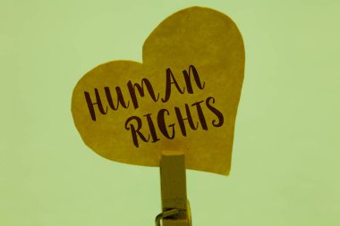 Word metin yazma insan hakları. Ahlaki ilkeleri standartları normlar hukuk sarı kağıt kalp önemli romantik mesaj fikirler tutan Clothespin tarafından korunan bir insan için iş kavramı.