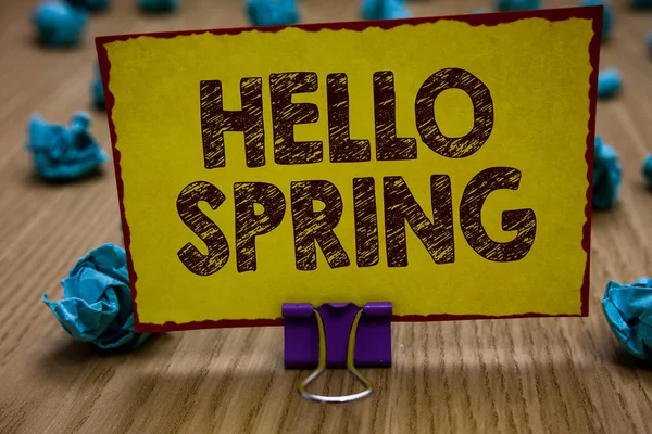 Conceptual hand writing showing Hello Spring. Business photo showcasing Welcoming the season after the winter Blossoming of flowers Clip holding yellow paper note crumpled papers several tries. — Stock Photo, Image