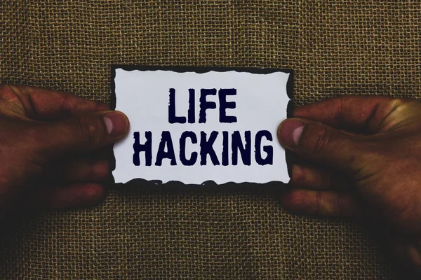 Handwriting text Life Hacking. Concept meaning Simple and clever techniques in accomplishing task easily Man holding piece paper black borders jute background Communicate ideas.