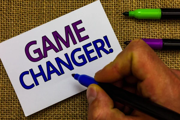Text sign showing Game Changer. Conceptual photo Sports Data Scorekeeper Gamestreams Live Scores Team Admins Man hand holding marker white paper communicating ideas Jute background.