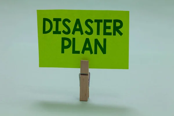 Conceptual hand writing showing Disaster Plan. Business photo showcasing Respond to Emergency Preparedness Survival and First Aid Kit Clothespin holding green paper important message ideas. — Stock Photo, Image