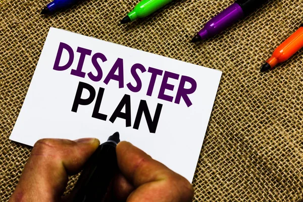 Writing note showing Disaster Plan. Business photo showcasing Respond to Emergency Preparedness Survival and First Aid Kit Man hand holding marker white paper communicating idea Jute background. — Stock Photo, Image