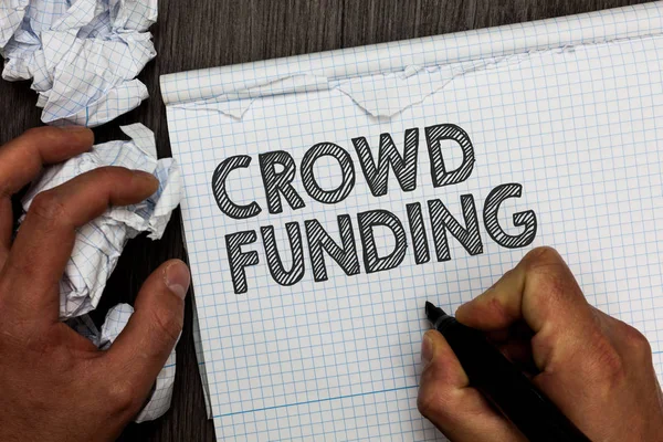 Word writing text Crowd Funding. Business concept for Fundraising Kickstarter Startup Pledge Platform Donations Man holding marker notebook crumpled papers several tries mistakes made. — Stock Photo, Image