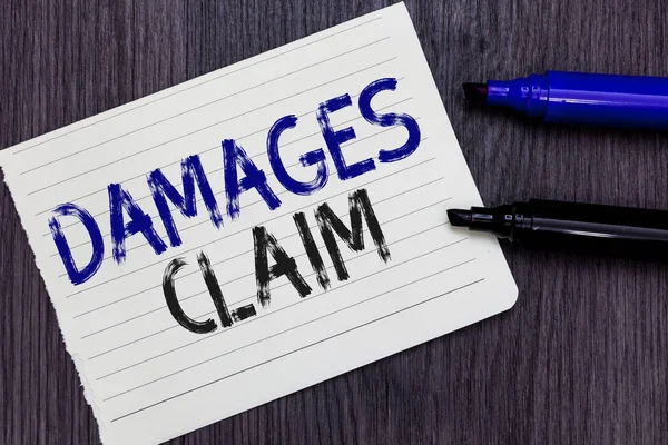 Writing note showing Damages Claim. Business photo showcasing Demand Compensation Litigate Insurance File Suit Notebook Paper Reminder Communicating ideas Markers Wooden background. — Stock Photo, Image