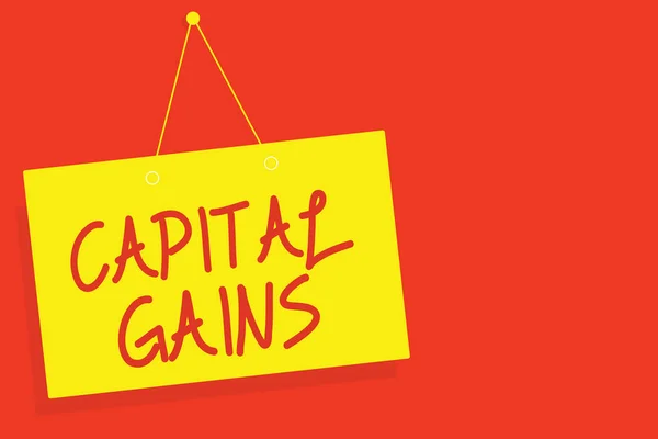 Handwriting text writing Capital Gains. Concept meaning Bonds Shares Stocks Profit Income Tax Investment Funds Yellow board wall message communication open close sign red background.