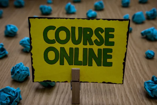 Text sign showing Course Online. Conceptual photo eLearning Electronic Education Distant Study Digital Class Clothespin holding yellow paper note crumpled papers several tries mistakes.