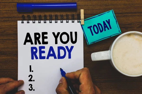 Conceptual hand writing showing Are You Ready. Business photo text Alertness Preparedness Urgency Game Start Hurry Wide awake Man holding marker notebook clothepin reminder wooden table coffee. — Stock Photo, Image
