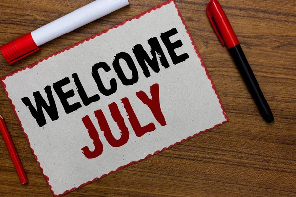 Text sign showing Welcome July. Conceptual photo Calendar Seventh Month 31days Third Quarter New Season White paper red borders markers wooden background communicating ideas. — Stock Photo, Image