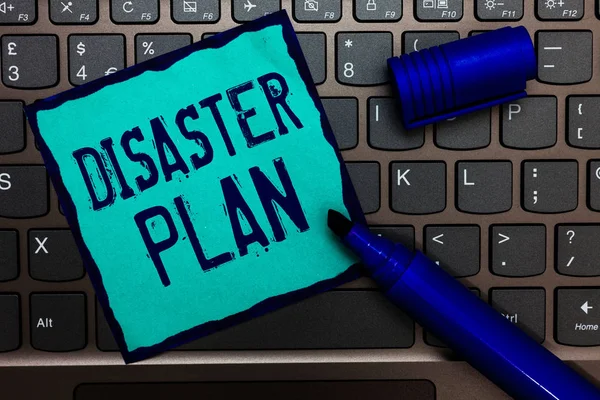 Word writing text Disaster Plan. Business concept for Respond to Emergency Preparedness Survival and First Aid Kit Turquoise paper keyboard Inspiration communicate idea messages blue markers.