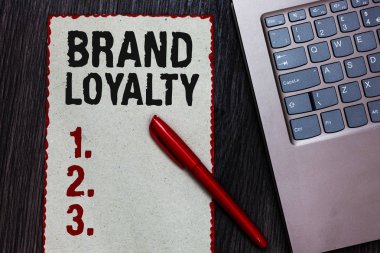 Marka sadakati yazma el yazısı metin. Siyah kalemi bilgisayar klavye ahşap arka plan tekrar satın alma Büyükelçi patronaj favori güvenilir parça kağıt kırmızı kenarlıklar anlam kavramı.