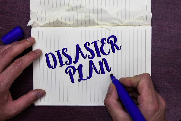 Writing note showing Disaster Plan. Business photo showcasing Respond to Emergency Preparedness Survival and First Aid Kit Man holding marker notebook page crumpled paper several tries mistakes. — Stock Photo, Image