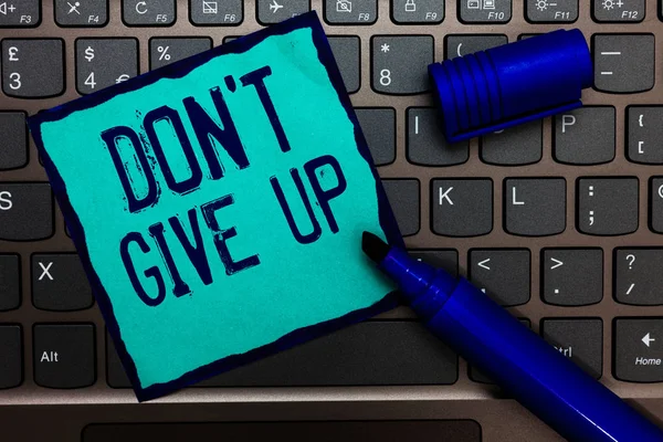 Word writing text Don t not Give Up. Business concept for Determined Persevering Continue to Believe in Yourself Turquoise paper keyboard Inspiration communicate idea messages blue markers.