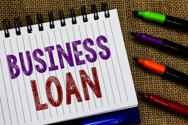 Text sign showing Business Loan. Conceptual photo Credit Mortgage Financial Assistance Cash Advances Debt Open spiral notebook page jute background colorful markers Expressing ideas.